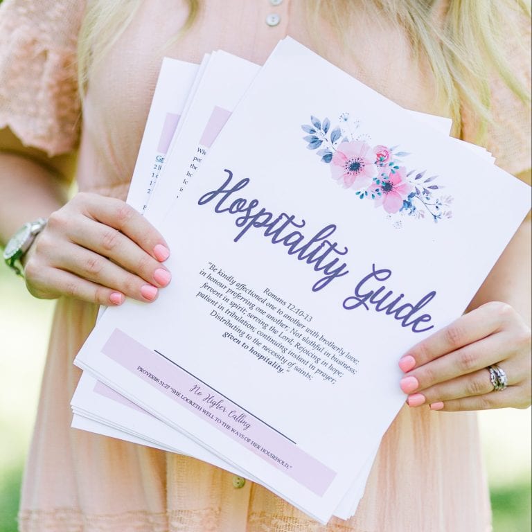 The Hospitality Guide being held by Brettnay Brazzell. They are slightly flayed out so that you can see it is multiple pages. She is wearing a peach colored dress.