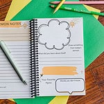 The Sermon Note Journal laying open. Displayed are pages which prompt kids to take notes as well as give some info about their favorite portions of the service