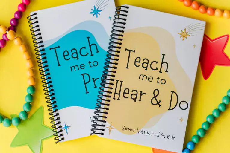 The Sermon Note Journal just barely on top of the Prayer Journal. Around them are bead bracelets and necklaces