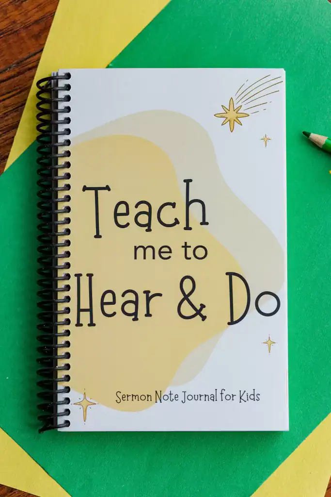 The Sermon Note Journal for Kids on green and yellow paper with colored pencils.