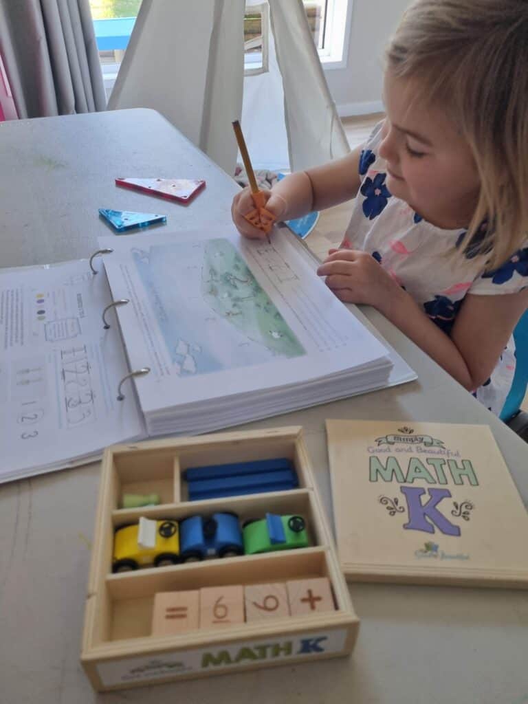 1. Child doing homeschool math with educational tools and workbook.